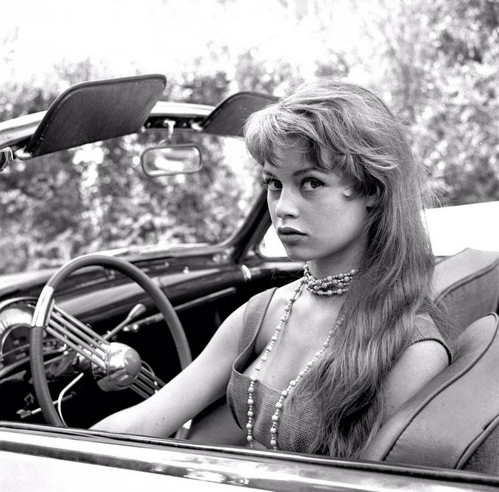 Brigitte Bardot in a convertible car