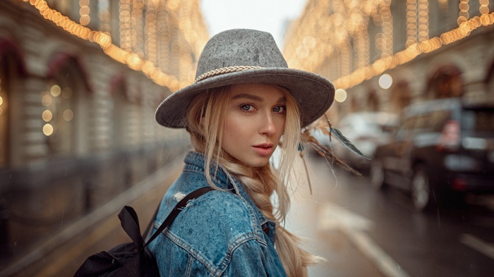 Woman in hat and jean jacket with blonde hair