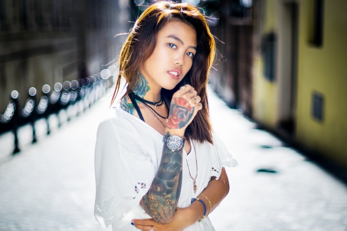 Asian woman with tattoos and watch
