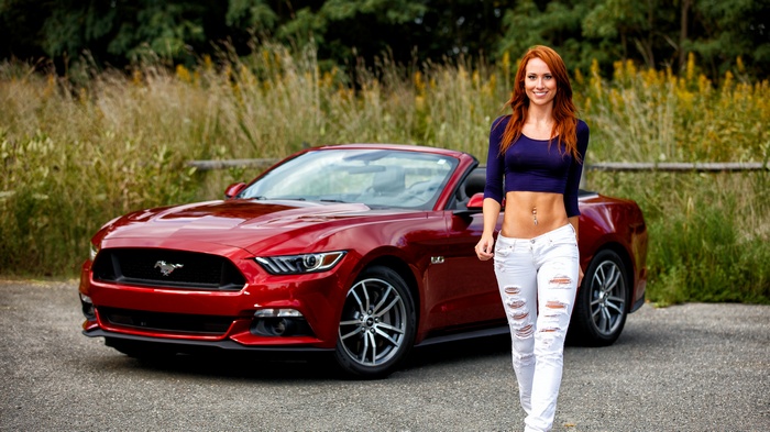 Redhead woman and red Ford Mustang convertible