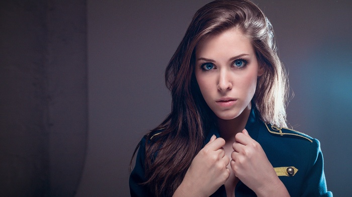 Woman in military-style jacket with blue eyes