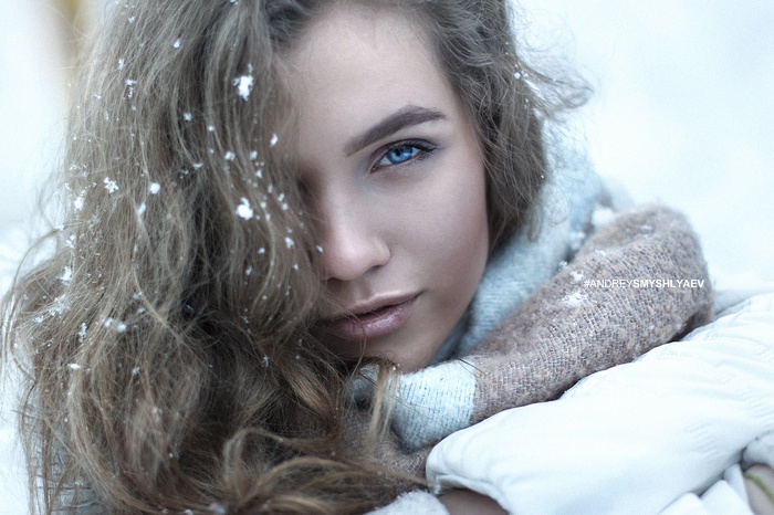 Woman with blue eyes and snow in her hair