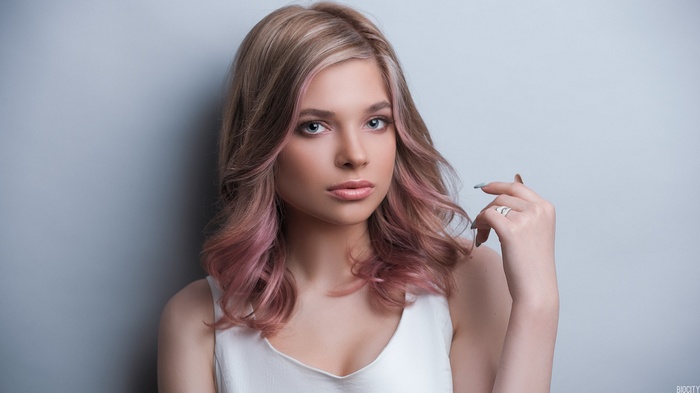 Portrait of a young woman with dyed blonde and pink hair