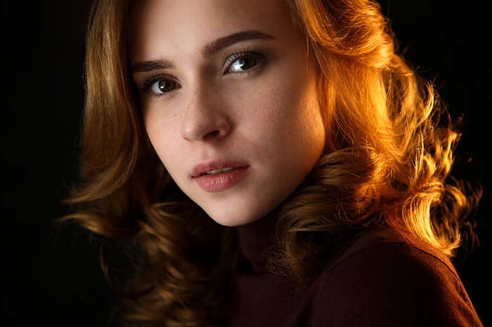 Portrait of a young woman with freckles