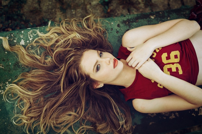 Woman with blonde hair wearing a red t-shirt
