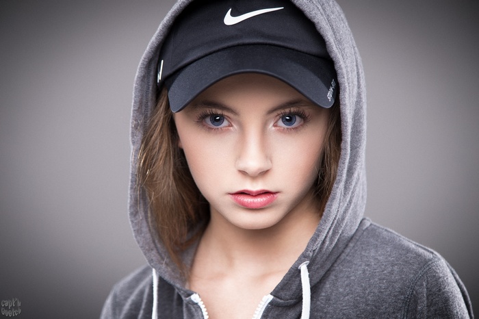 Young woman wearing a Nike baseball cap and hoodie
