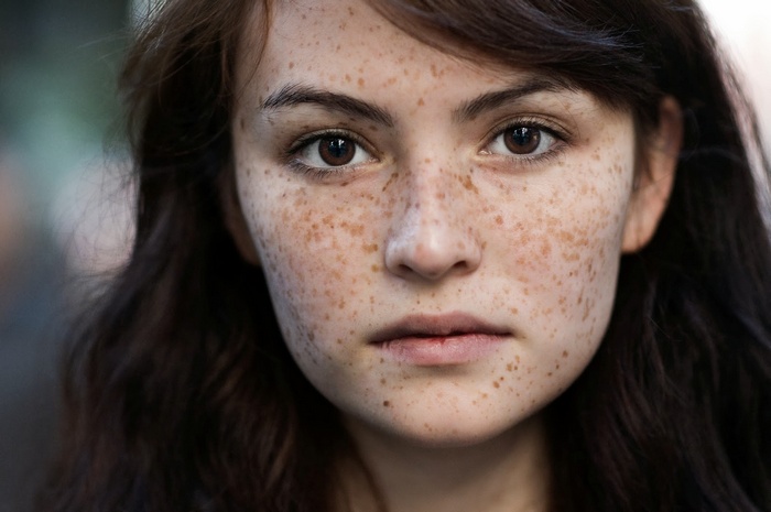 Portrait of a young woman with freckles