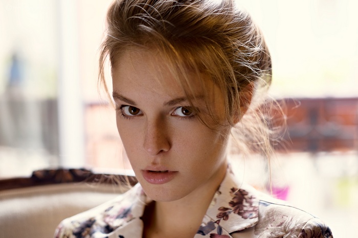 Portrait of a young woman with blonde hair and freckles