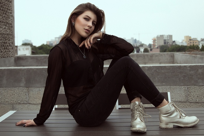 Woman in black sitting on a table