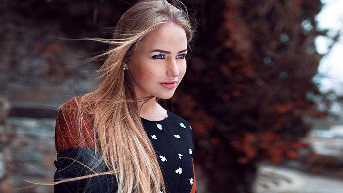 Woman with blonde hair and blue eyes outdoors