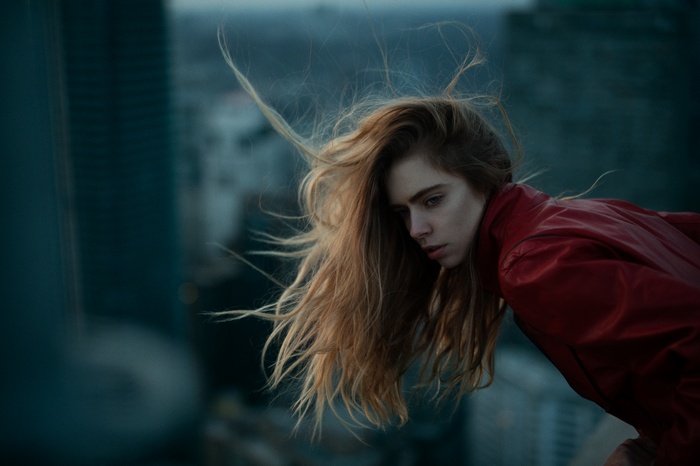 Woman with long blonde hair in red jacket