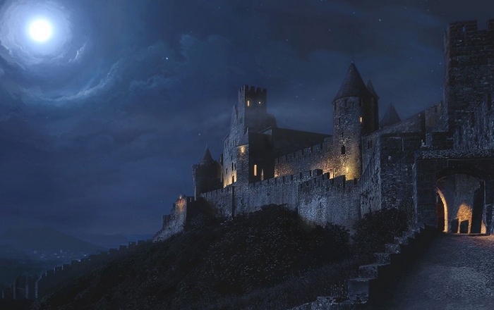 Castle at night under a full moon