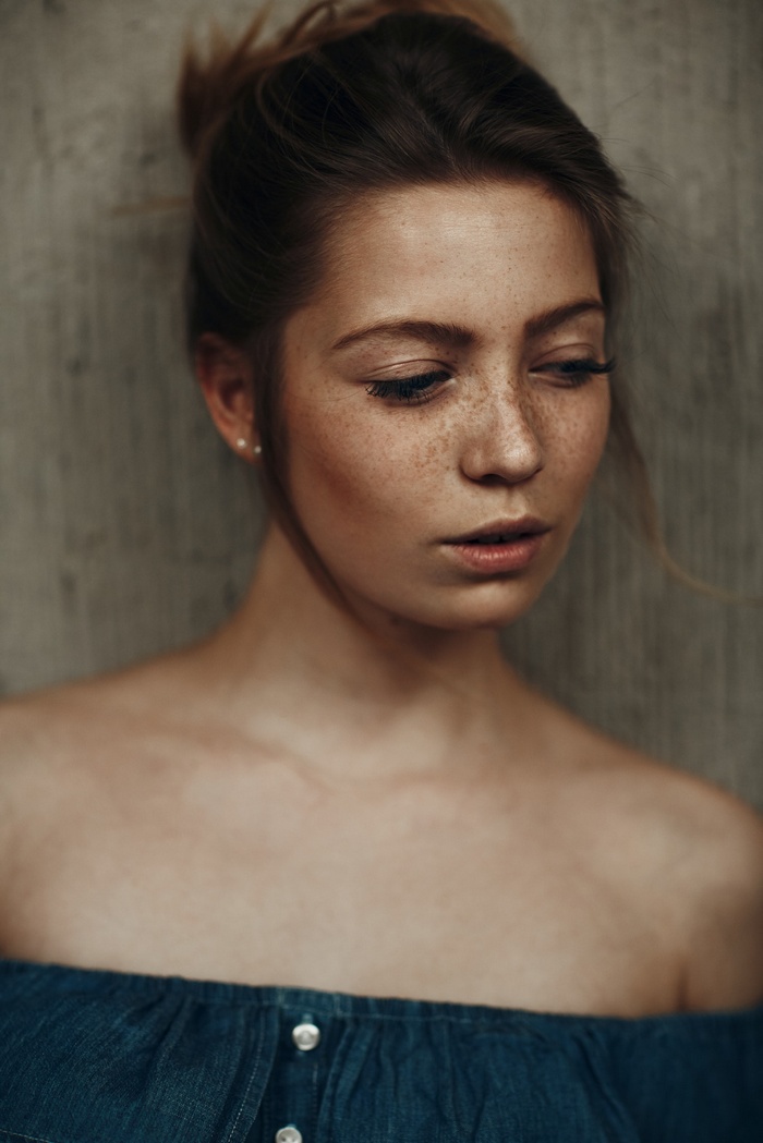 Portrait of a young woman with freckles