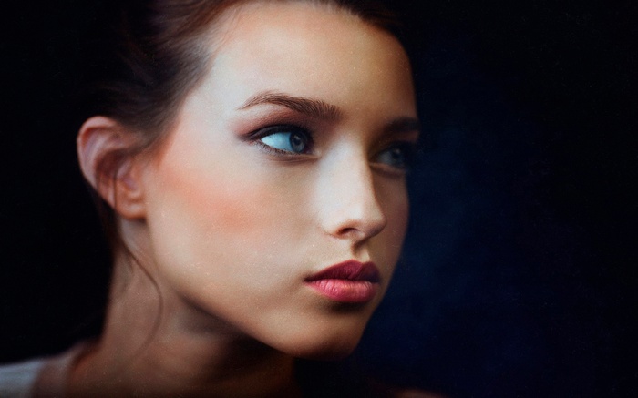 Portrait of a woman with blue eyes and red lipstick