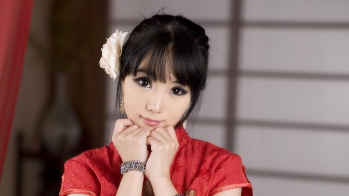 Woman in red Cheongsam with white flower in hair