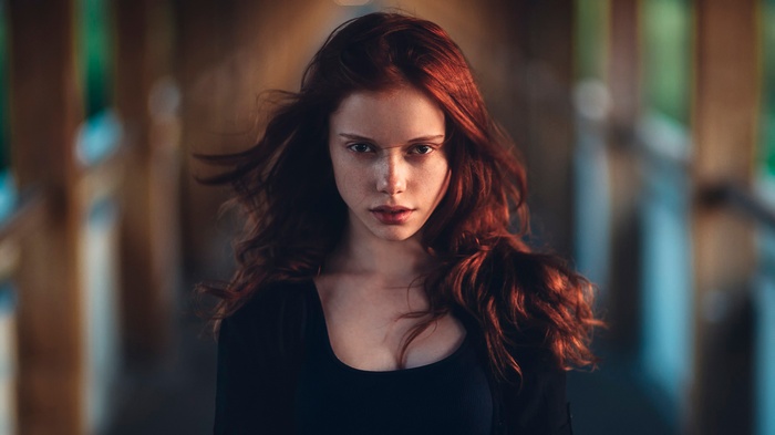Redhead woman with freckles looking at viewer