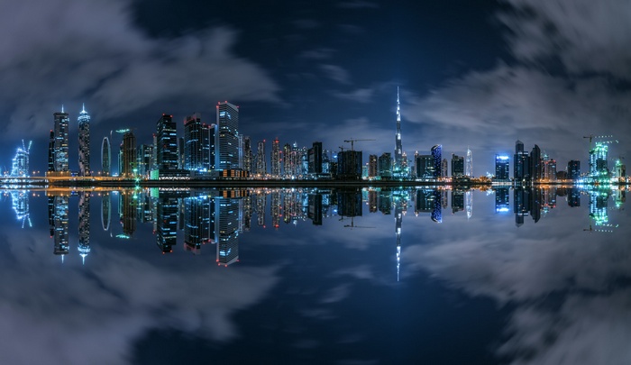Dubai cityscape with reflections at night