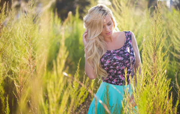 Aida Ridic in a floral top and turquoise skirt outdoors