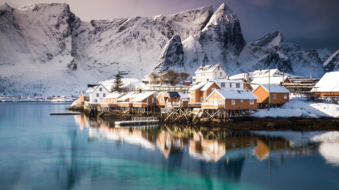 Snowy town on the sea with mountains in Lofoten Islands, Norway
