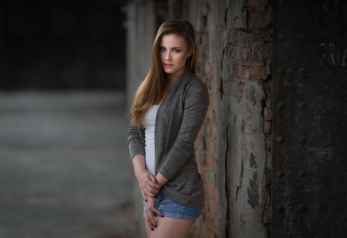white tops, women, depth of field, painted nails, earring, long hair, wall, looking at viewer, jean shorts, straight hair, portrait, women outdoors, blue eyes