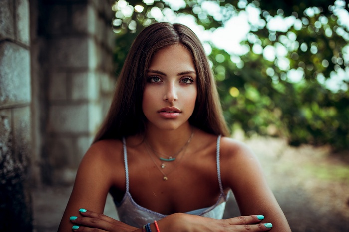 Woman with long brown hair and necklaces