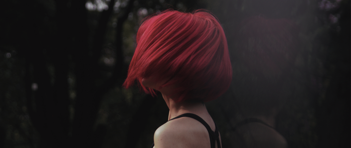 Woman with short red hair from behind