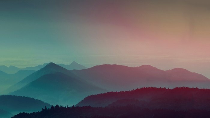 Misty mountains at sunrise with colorful sky