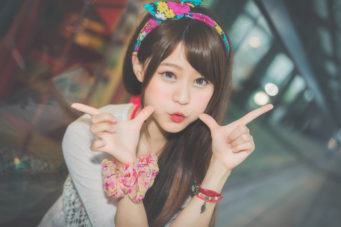 Young Asian woman with colorful headband and bracelets