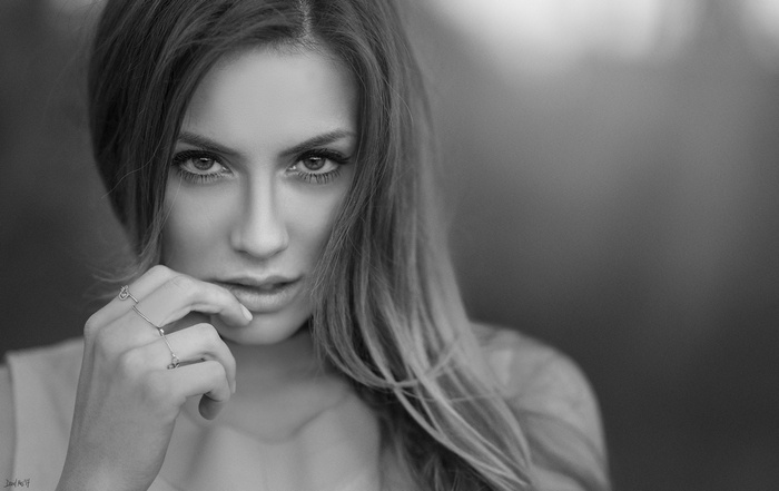 Monochrome portrait of a woman with hand to mouth
