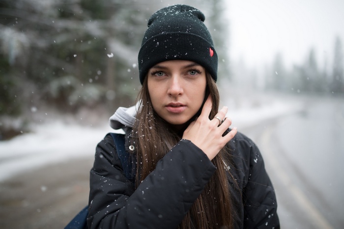 Woman in black jacket and beanie in snow