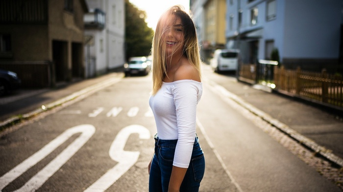 Woman in white top and jeans on a street