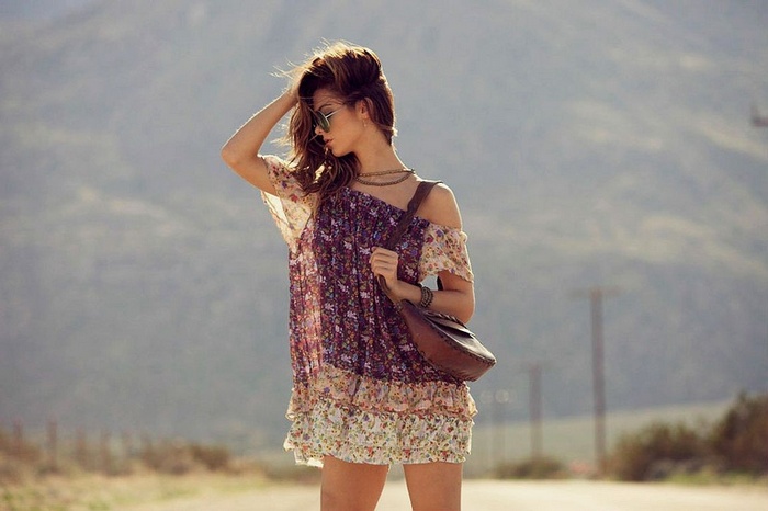 Carmella Rose in a floral dress with a handbag