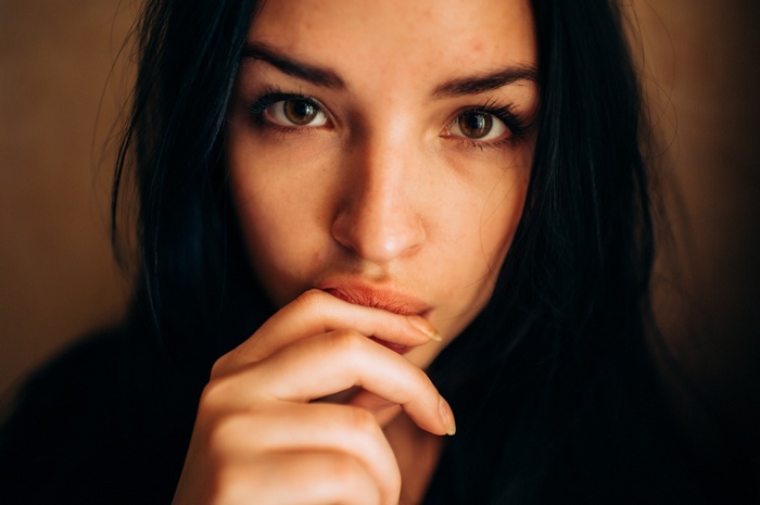 Portrait of a woman with her finger on her lips