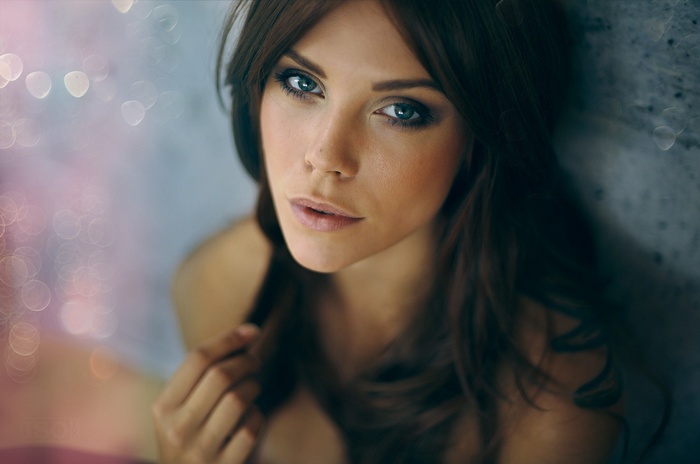 Portrait of a woman with bare shoulders and bokeh background