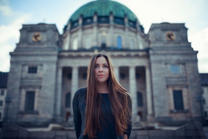 Woman in front of a large domed building