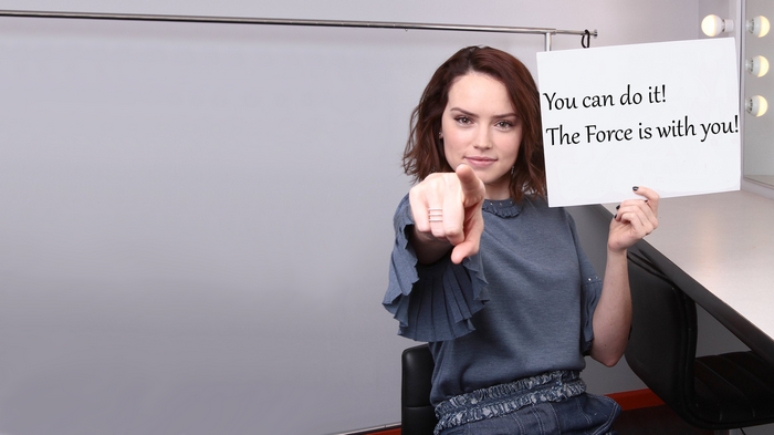 Daisy Ridley from Star Wars holding a sign