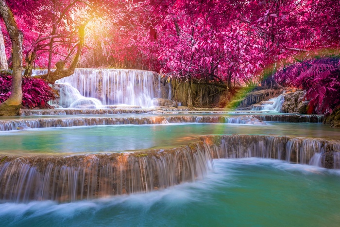 Waterfall with pink trees and rainbow effect