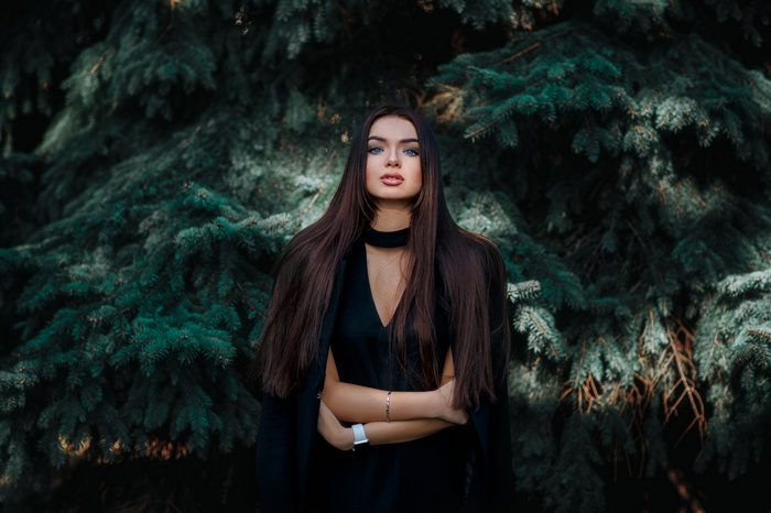 Woman with long brown hair in black dress