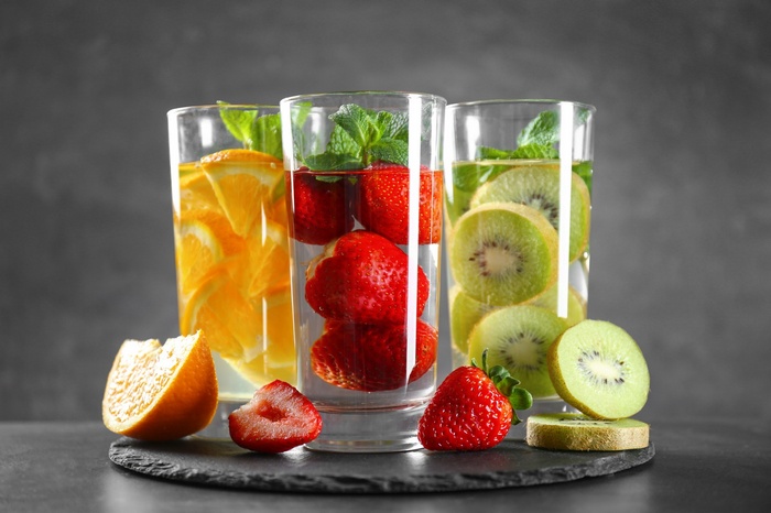 Three glasses of infused water with fruit and mint