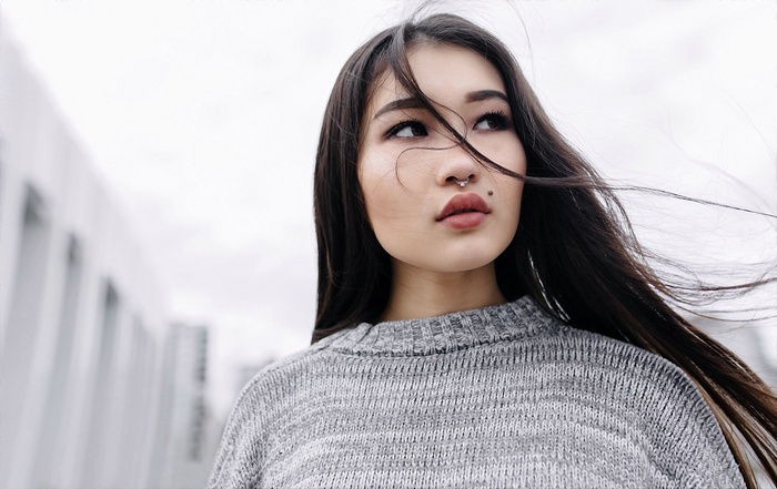 Woman with nose ring and mole on face