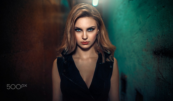 Woman with blonde hair and blue eyes in black clothing