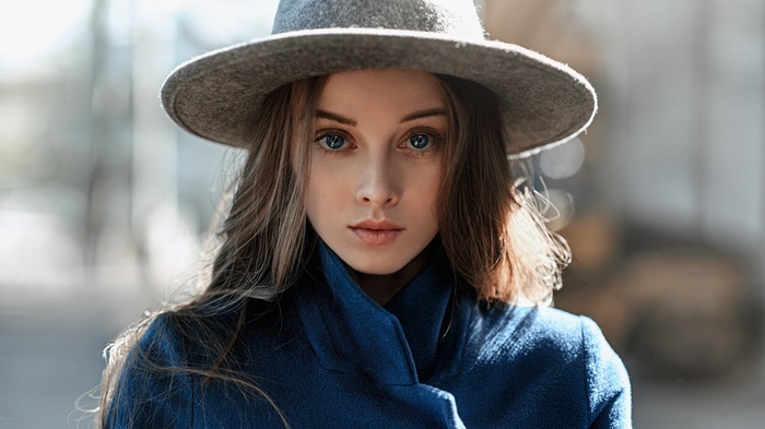 Woman wearing a hat and blue coat