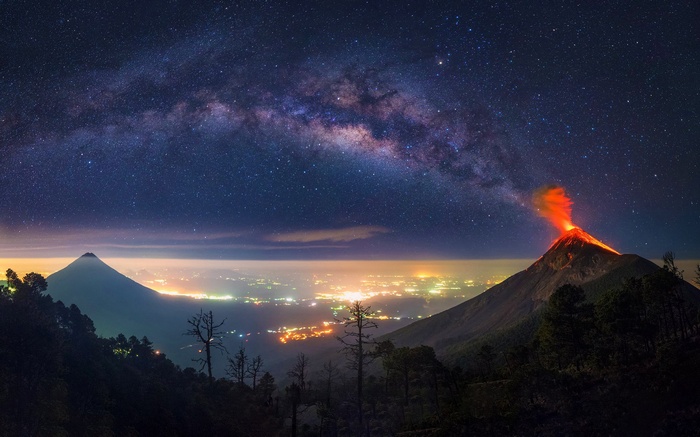 Volcano erupting under the Milky Way in Guatemala