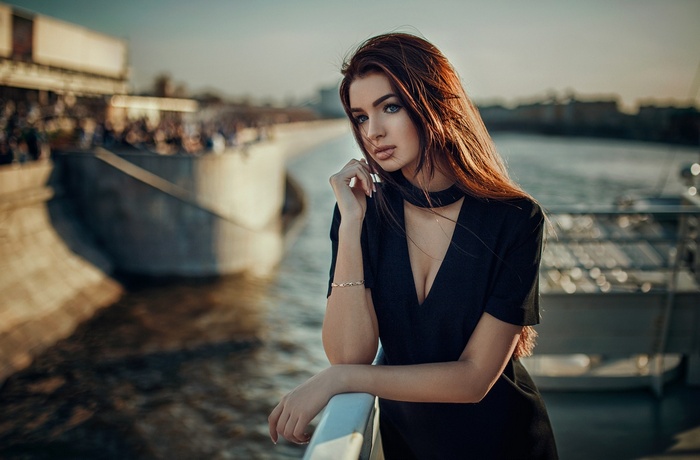 Woman in black dress by the water