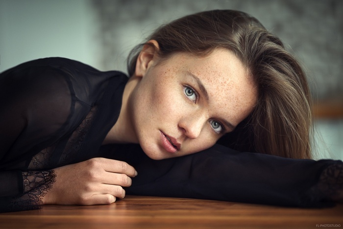 Woman with freckles lying down