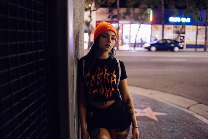Woman in orange beanie and flame T-shirt on Hollywood Boulevard