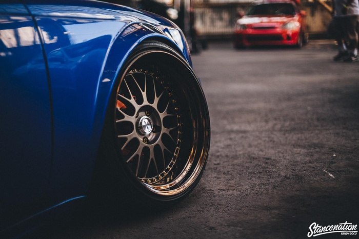Blue modified sports car with Vossen wheels