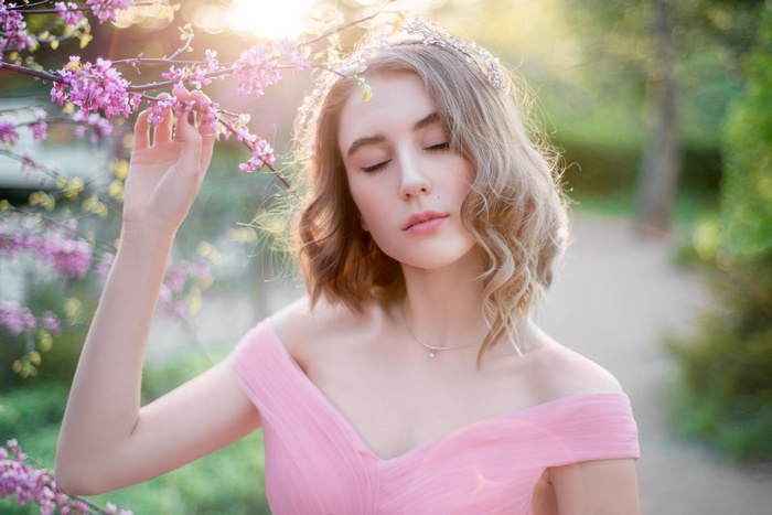 Woman in pink dress with tiara in spring