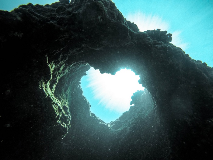 Underwater cave opening with sun rays