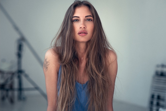 Woman with long brown hair and tattoo
